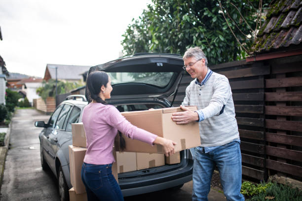 istock Father Helping His Young Daughter Carry Boxes Into New Apartment 1287214259