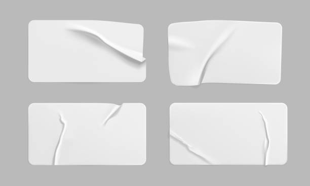 istock White glued crumpled rectangle stickers mock up set. Blank white adhesive paper or plastic sticker label with wrinkled and creased effect. Template label tags close up. 3d realistic vector 1287214424