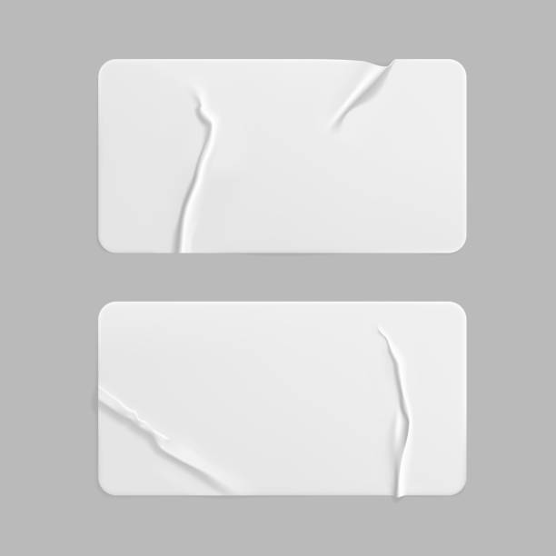 istock White glued crumpled rectangle stickers mock up set. Blank white adhesive paper or plastic sticker label with wrinkled and creased effect. Template label tags close up. 3d realistic vector 1287214593