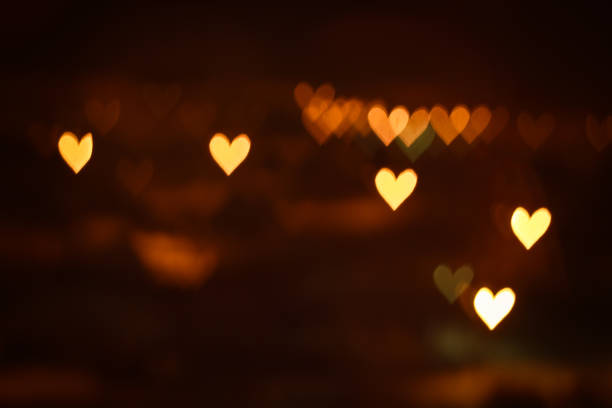 istock Heart shape bokeh lights on dark background. City lights defocused 1287217540