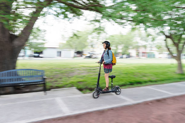 istock Young woman riding motorized scooter outside 1287218534