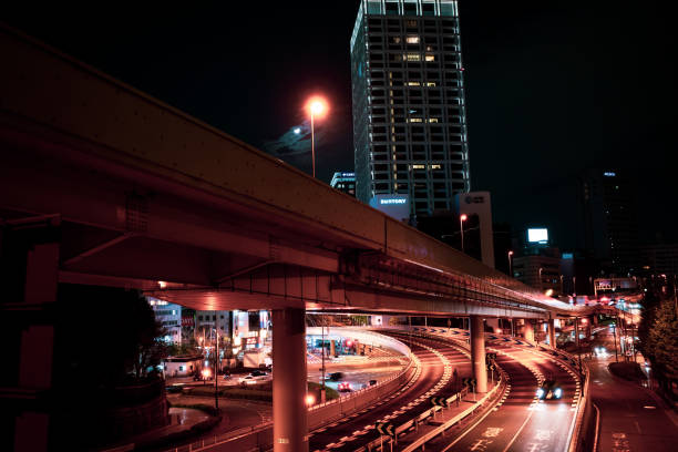 istock Light trails on city street against sky at night 1287219290