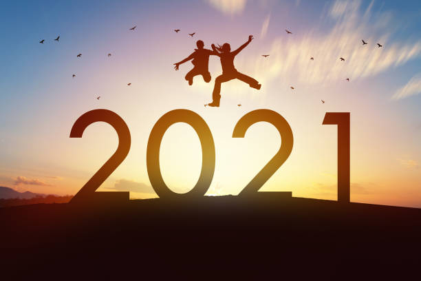 Happy family jump over 2021 with sunset background