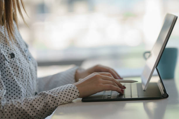istock female office worker concentrating on her work with a digital tablet. 1287220509