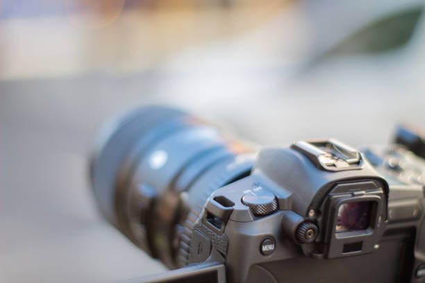 istock Camera on tripod up-close recording the blurry street 1287222062