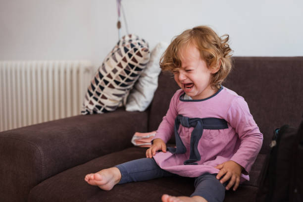 istock Young girl crying hysterically on a sofa 1287223791