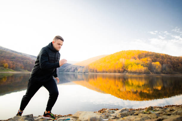 istock Active young men working out on the lake's waterfront 1287225920