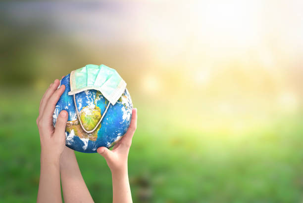 istock hands holding earth globe on natural background. Elements of this image furnished by NASA 1287226749