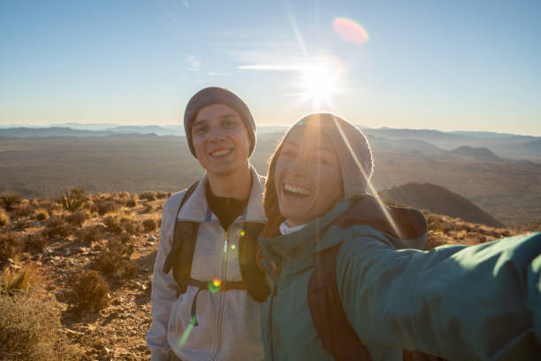 istock Hikers take selfie on mountain top at sunrise 1287227566
