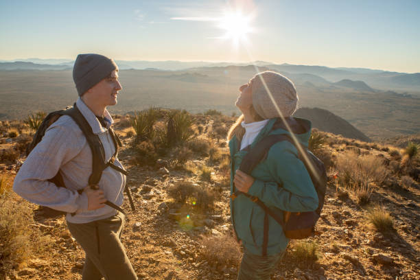 istock Hikers reach mountain top at sunrise 1287228309