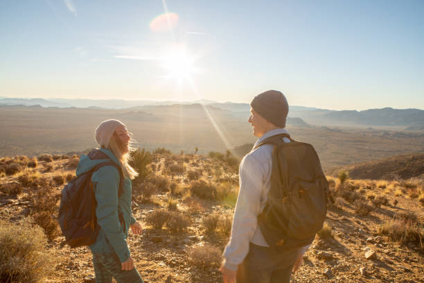 istock Hikers reach mountain top at sunrise 1287228421