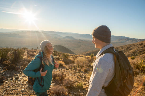 istock Hikers reach mountain top at sunrise 1287228429
