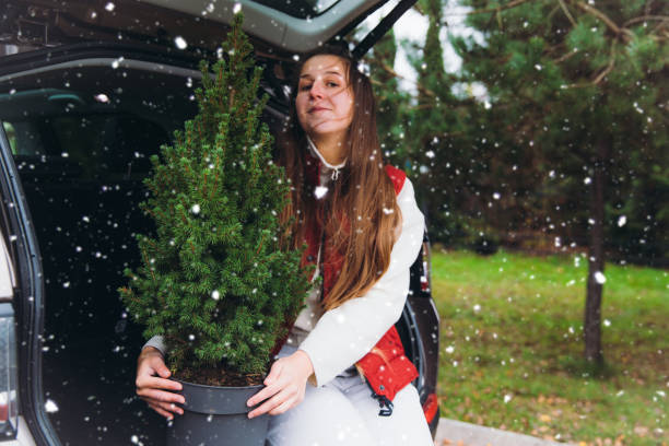 istock Young smiling woman has a Christmas preparations during the first snow 1287228544