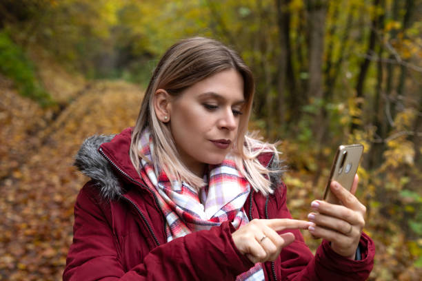 istock Woman making online content outdoor-autumn 1287230572