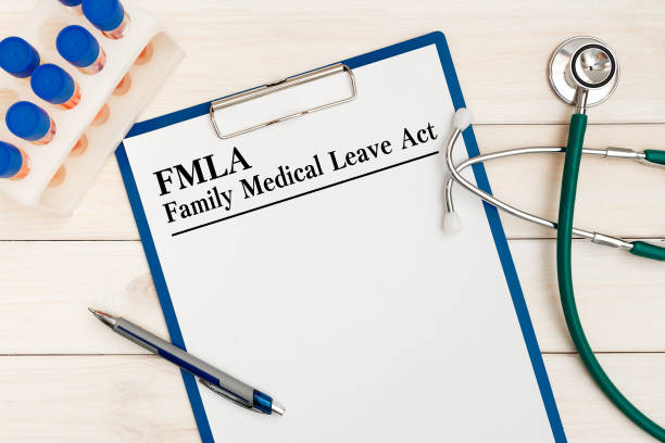 Paper with Family Medical Leave Act FMLA on a table, stethoscope and pen stock photo