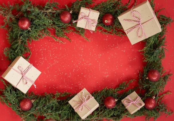 istock Flat lay new year Christmas craft boxes, balls and pine tree on red paper background. 1287237316