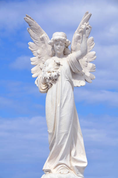 istock White angel grave yard statue with blue sky 1287237850