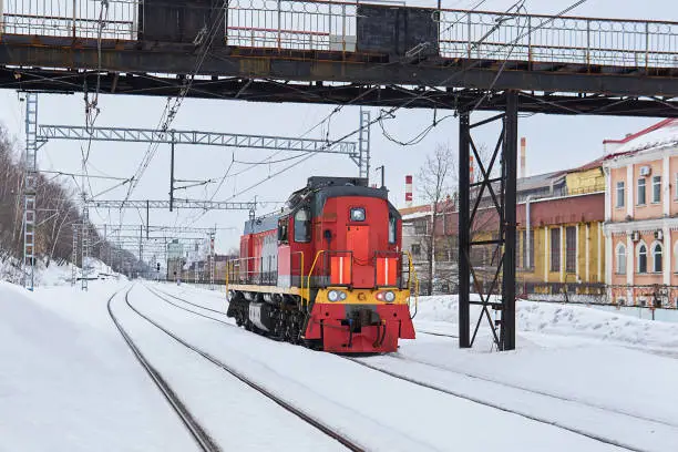 shunting locomotive on a railway track in an industrial area on a cloudy winter day