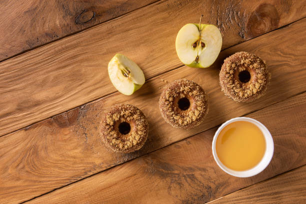 istock Apple cider doughnuts and ingredients on wood 1287239345
