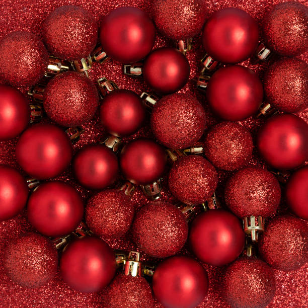 istock Christmas baubles on a red glittering background. 1287239366