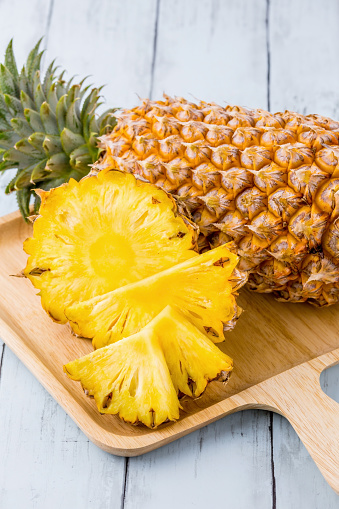 Pineapple fresh fruit on blue wooden background