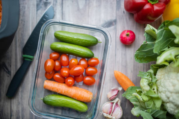 istock Carrots, zucchini, tomatoes, and more vegetables on a wooden table 1287241604