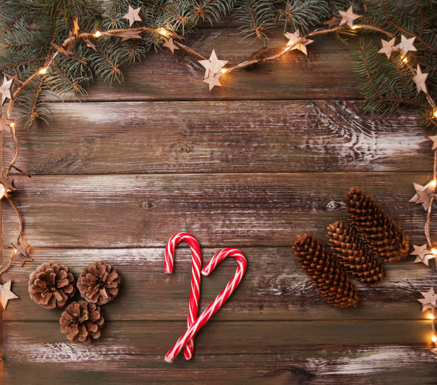 istock Christmas wooden background with garland. Flat lay. 1287242638