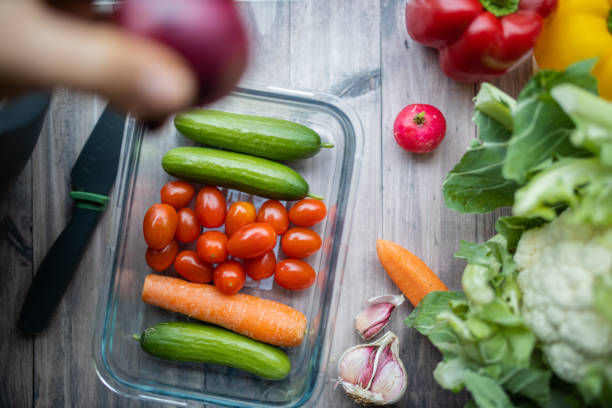 istock Carrots, zucchini, tomatoes, and more vegetables on a wooden table 1287244294