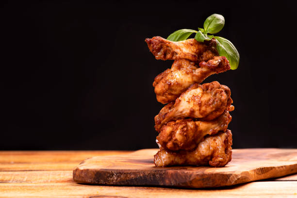 istock Fried chicken wings on the board. 1287245162