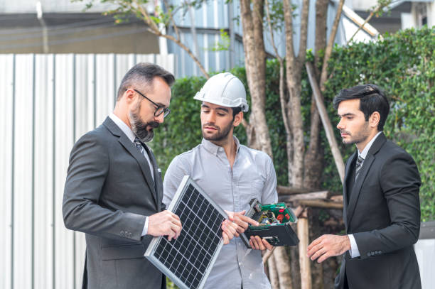 istock Two Businessman and power engineering talking and checking quality power solar cell with laptop computor on site new project power solution business 1287246298