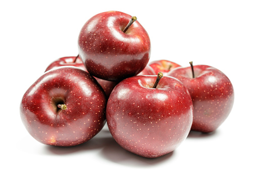 Many ripe red apples isolated on a white background.