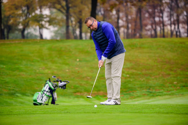 istock With a putt, hit the hole with the golf ball 1287247246