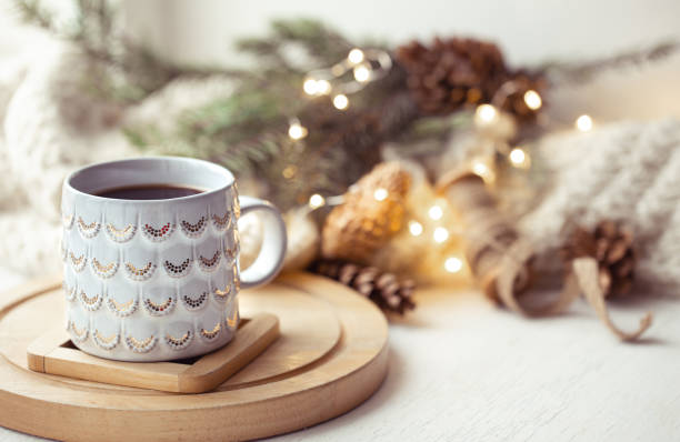 istock Beautiful cup with hot drink close up on blurred background with bokeh lights. 1287247587
