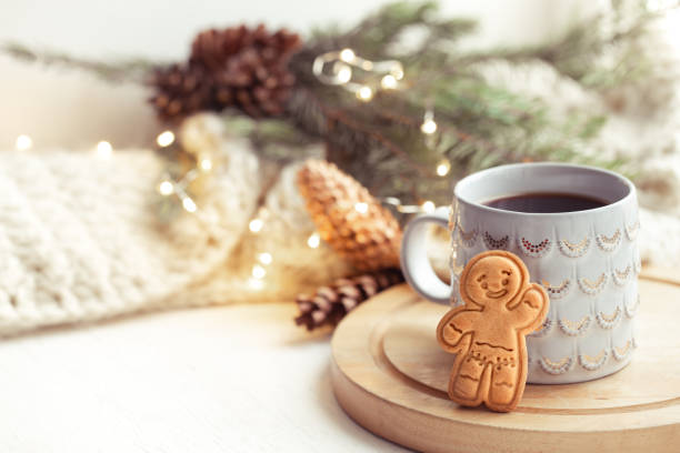 istock Christmas composition with gingerbread boy and beautiful cup with hot drink close up. 1287247595