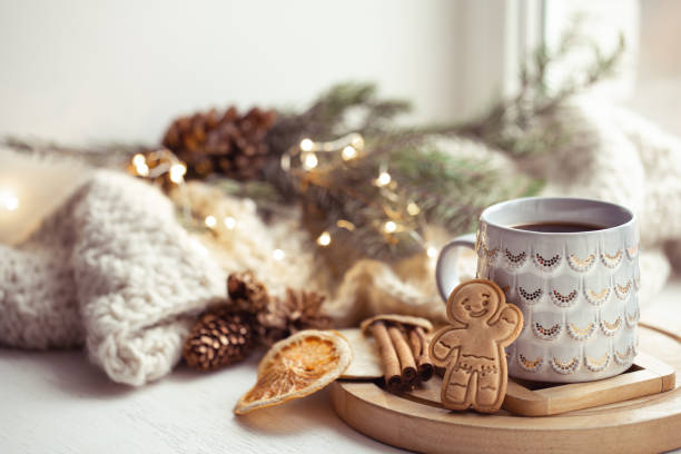 istock Beautiful cup with handmade gingerbread boy on a cozy blurred background with lights. 1287247604