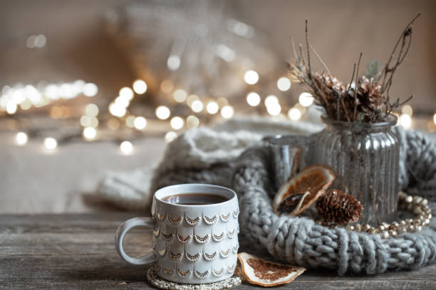 istock Cozy composition with a Christmas cup on a blurred background with lights. 1287247646