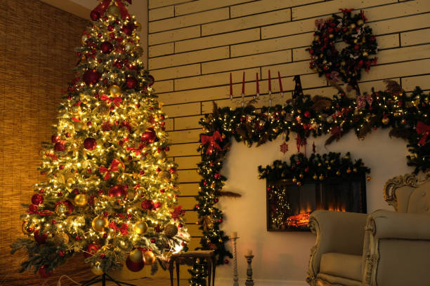 istock New Year tree with Christmas decorations lights and fireplace 1287248666