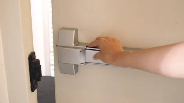 istock Hand is pushing Fire door handle of Fire exit for emergency evacuation. 1287249031