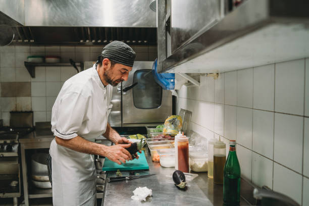 istock Chef cutting the aubergines in the restaurant's kitchen 1287249428