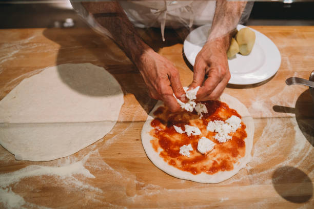 istock Pizza chef preparing a pizza at the restaurant 1287249460