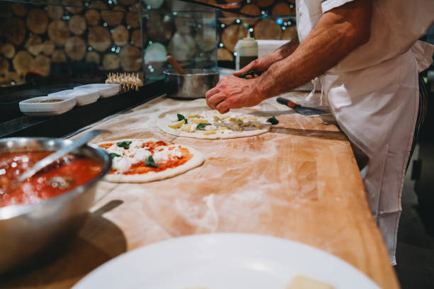 istock Pizza chef preparing a pizza at the restaurant 1287249461