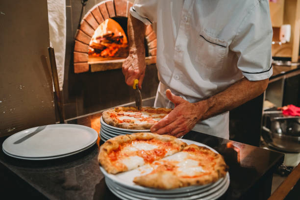 istock Pizza chef preparing pizza at the restaurant 1287249462