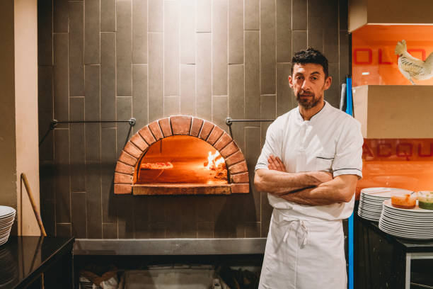 istock Portrait of a pizza chef inside his pizzeria 1287249465