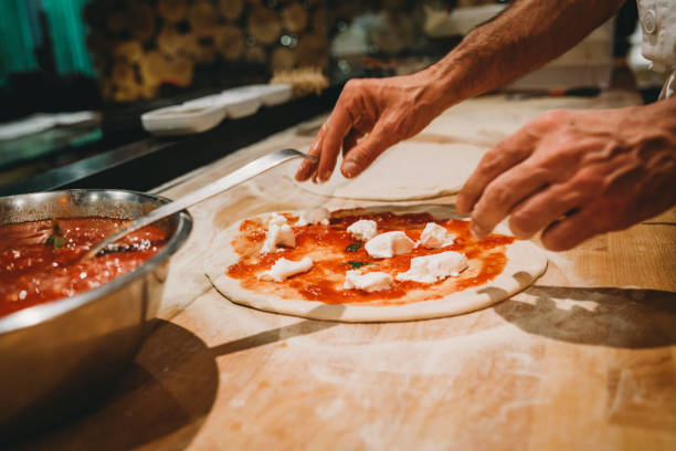 istock Pizza chef preparing a pizza at the restaurant 1287249477