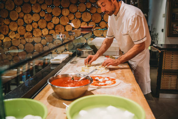 istock Pizza chef preparing a pizza at the restaurant 1287249481