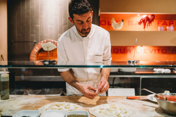 istock Pizza chef preparing a pizza at the restaurant 1287249496