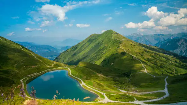 Austria, Kleinwalsertal, Small mountain lake reflecting clouds and sky at peak of kanzelwand mountain in alps mountains nature landscape