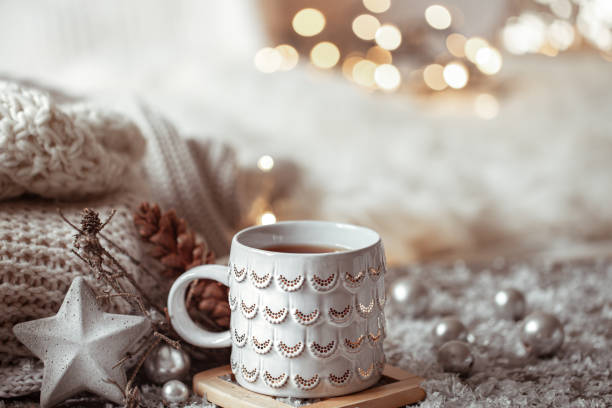 istock Cozy winter background with a beautiful cup, decor details and bokeh. 1287249607