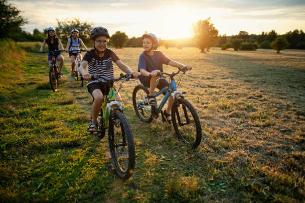 Family riding bikes on sunny summer day