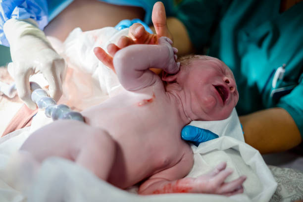 istock Crying newborn baby boy still with umbilical cord. 1287251315